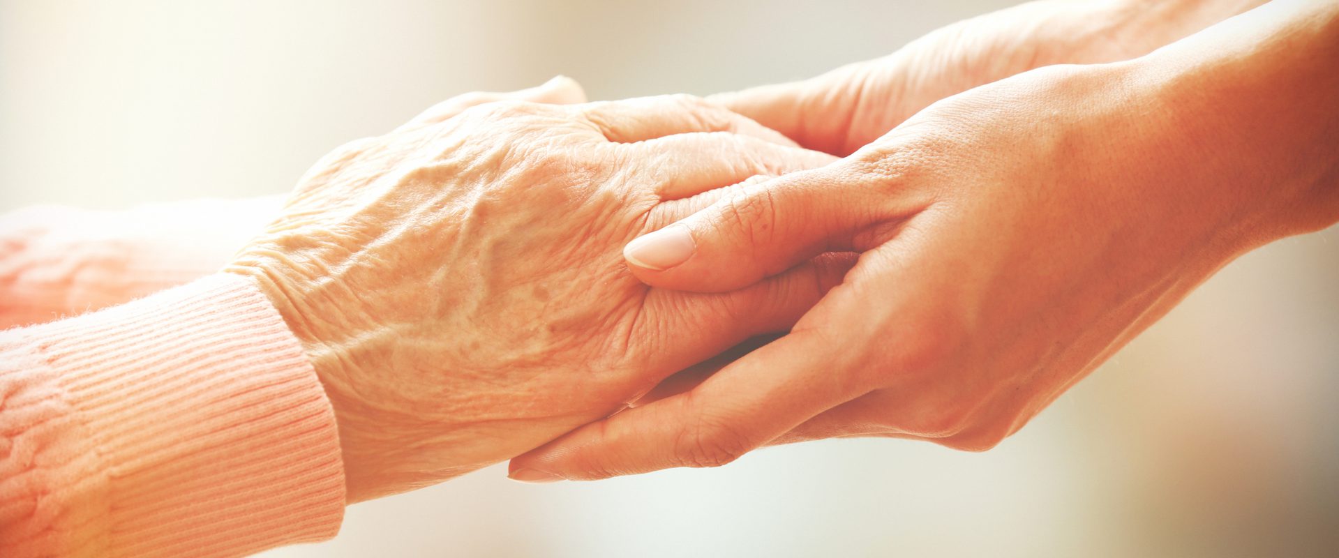 Holding the hand of an elderly person who has a lasting power of attorney