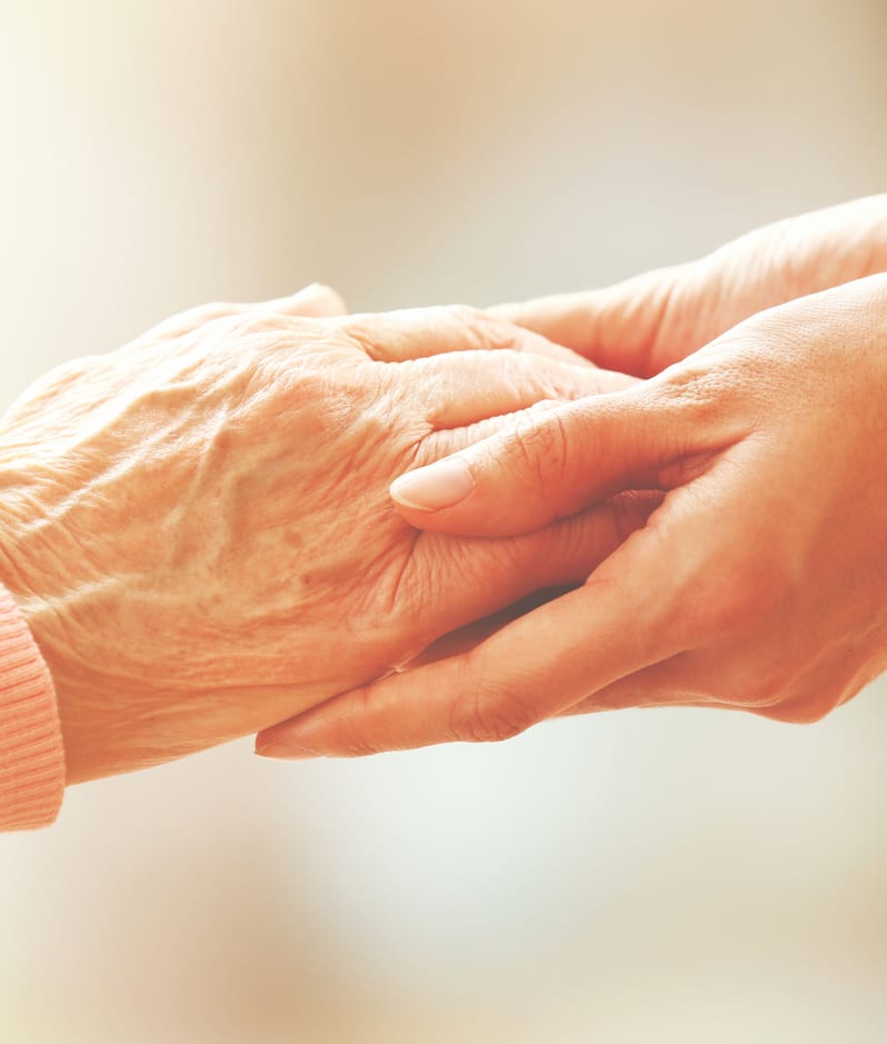 Holding the hand of an elderly person who has a lasting power of attorney