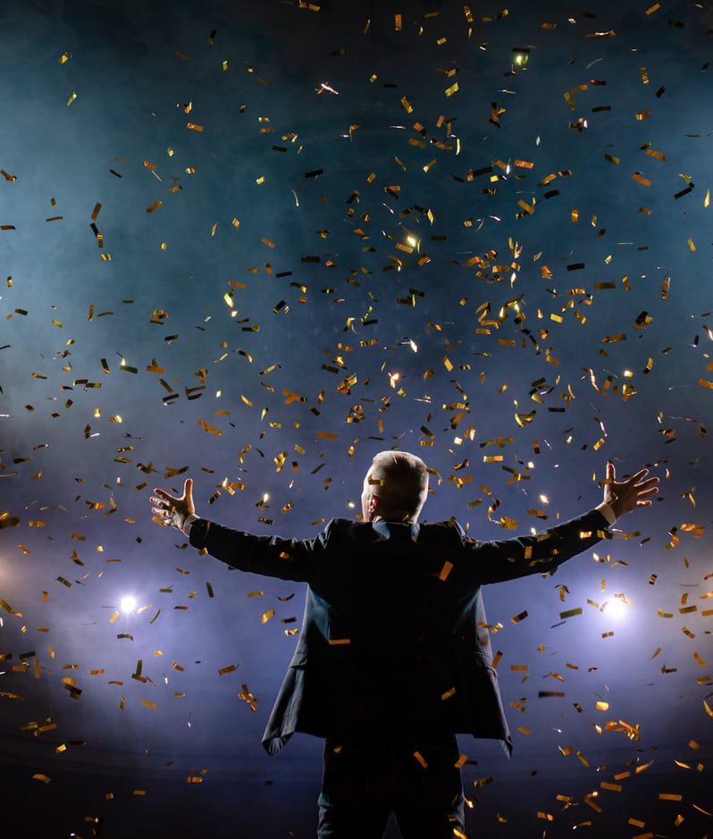 Successful businessman arms raised