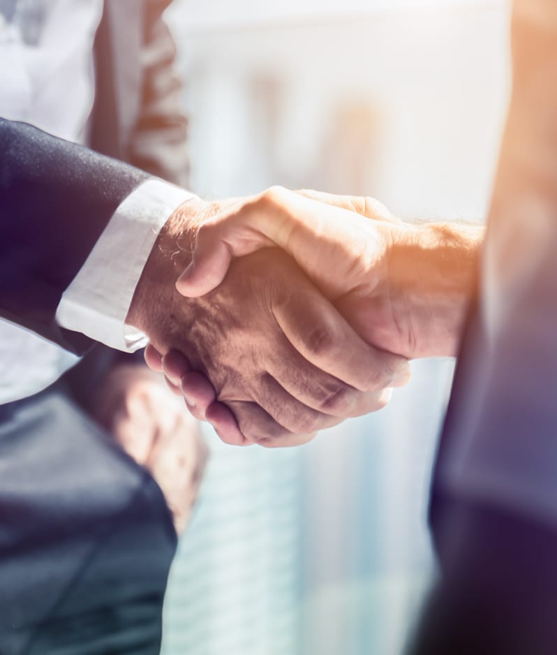 Two businesspeople shaking hands camera blur and effects