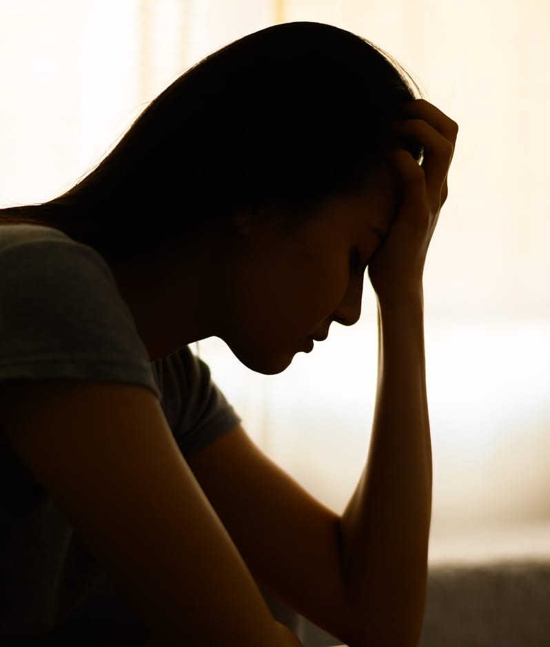 Woman with head in hands silhouette