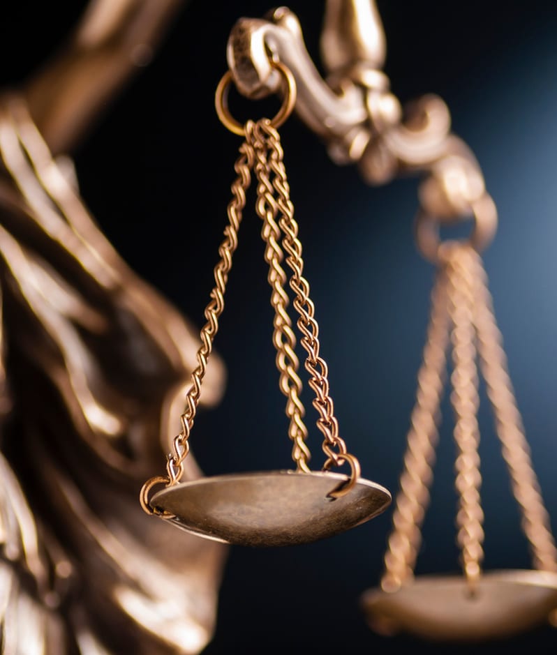 Gold scales of justice close up