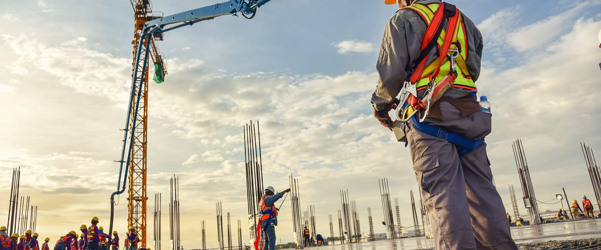 Construction workers building crane