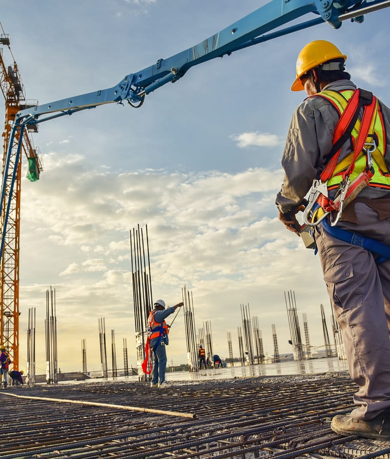 Construction workers building crane