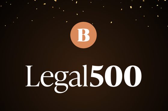 Dark brown gradient background with scattered gold confetti, a peach circular badge containing a white B, and large white serif text reading Legal500.