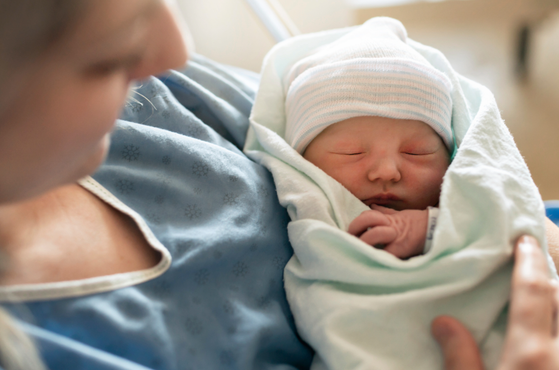 Mother and baby in hospital receiving neonatal care