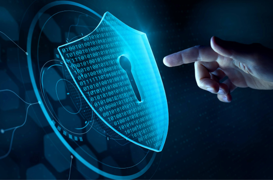 Blue digital shield with a keyhole and binary code, glowing rings around it, while a hand reaches towards the shield, representing cybersecurity and protection.