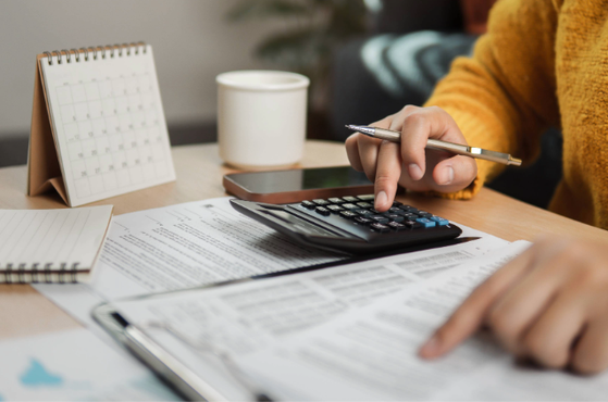 Woman in yellow jumper completes her tax return