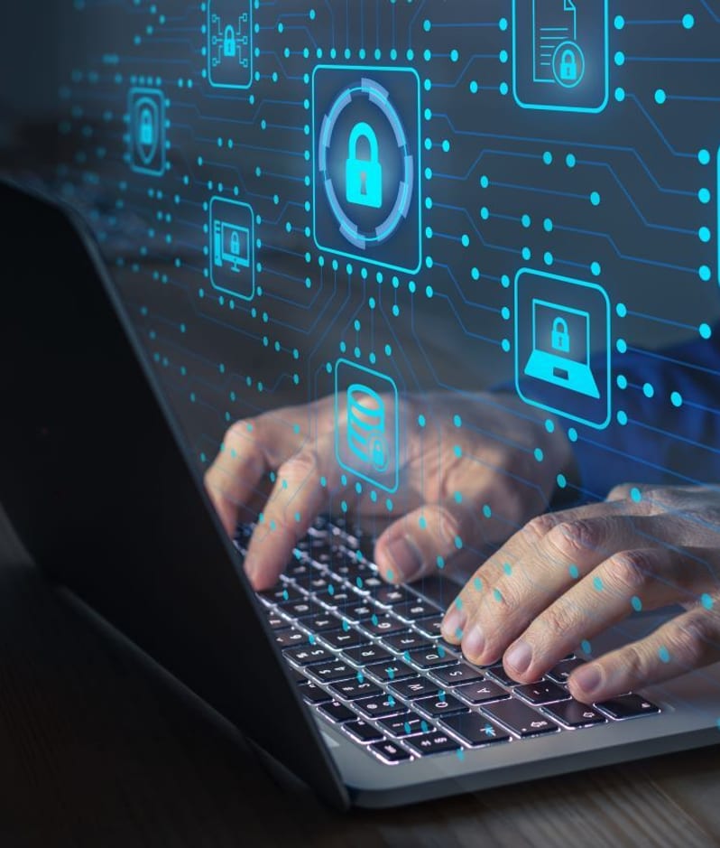 hands typing on a laptop protecting IP assets.