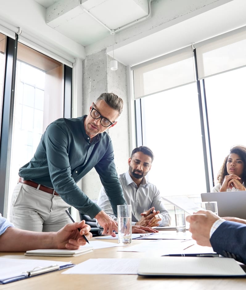 Company team discuss business matter around a table